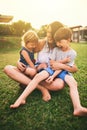 Mother, happy children or hug playing on grass for fun bonding in summer outside a house in nature. Funny mom hugging Royalty Free Stock Photo