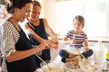 Mother, happy family or kids baking in kitchen with siblings learning cookies recipe or mixing pastry at home. Mom Royalty Free Stock Photo