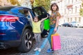 Mother and the happy girl with purchases near the car Royalty Free Stock Photo