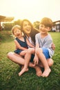 Mother, happy kids or hug playing on grass for fun bonding in summer outside a house in nature. Funny mom hugging Royalty Free Stock Photo