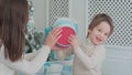 Mother and happy son checking gifts sitting near the Christmas tree Royalty Free Stock Photo