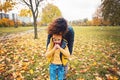 Mother and happy son child boy walking in autumn park Royalty Free Stock Photo