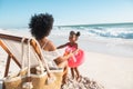 Mother having fun with her cute little girl with flamingo inflatable at beach Royalty Free Stock Photo