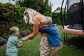 Mother having fun with sons in the garden, bonding moment. Concept of Mother& x27;s Day, and motherly love.