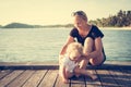 Mother help her child baby to get up beach sea pier summer vacation Royalty Free Stock Photo