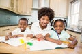 Mother helping children do their homework Royalty Free Stock Photo
