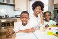 Mother helping children do their homework Royalty Free Stock Photo