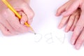 Mother helping daughter write alphabet