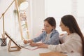 Mother helping her daughter with homework using tablet at home Royalty Free Stock Photo