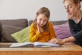 Mother helping her daughter to do school homework Royalty Free Stock Photo