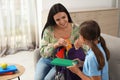 Mother helping her daughter to get ready for school at home Royalty Free Stock Photo