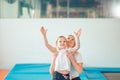 Mother helping daughter to play sports on gymnastic rings Royalty Free Stock Photo