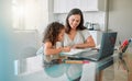 Mother helping her girl with writing her homework of a happy family house in her creative kids notebook. Mom, education Royalty Free Stock Photo