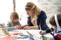 Mom helping her kids with homeschooling during the lockdown