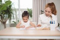 Mother helping her little child with homework Royalty Free Stock Photo