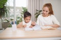 Mother helping her little child with homework Royalty Free Stock Photo