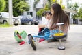 Mother helping her little daughter after falling off bicycle outdoors Royalty Free Stock Photo