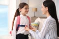 Mother helping her little daughter to get ready for school Royalty Free Stock Photo