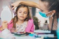 Mother helping her little girl with make up Royalty Free Stock Photo