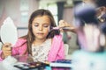 Mother helping her little girl with make up Royalty Free Stock Photo