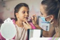 Mother helping her little girl with make up Royalty Free Stock Photo