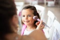 Mother helping her little girl with make up Royalty Free Stock Photo