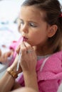 Mother helping her little girl with make up Royalty Free Stock Photo