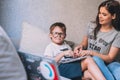 Mother helping her son with homework at home room