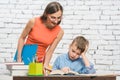 Mother helping her son to do the school homework Royalty Free Stock Photo