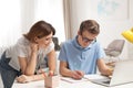 Mother helping her teenager son with homework