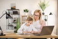 Mother helping his son with his homework at home. Royalty Free Stock Photo