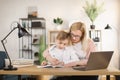 Mother helping his son with his homework at home. Royalty Free Stock Photo