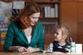 Mother helping kid after school. preschooler doing homework with help of tutor. home teaching concept. Royalty Free Stock Photo