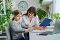 Mother helping preteen daughter to study, looking at laptop at home Royalty Free Stock Photo