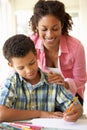 Mother Helping Son With Homework At Home Royalty Free Stock Photo