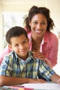 Mother Helping Son With Homework At Home Royalty Free Stock Photo