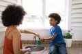 Mother helping son to wash his hands at home Royalty Free Stock Photo