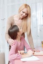 Mother helps daughter with the home work Royalty Free Stock Photo
