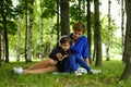 Mother helps her daughter with distant education outside in the park.