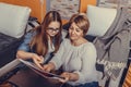 Mother helps her teenage daughter with homework, learning and reading book together Royalty Free Stock Photo