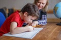 Mother helps son learning at home