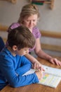 Mother helps to son solving mathematics homework Royalty Free Stock Photo