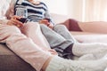 Mother and her adult drinking wine sitting on couch at home. Women talking and relaxing Royalty Free Stock Photo