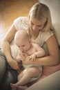 Mother with her baby boy on bed. Close up. Royalty Free Stock Photo