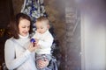 Mother with her baby boy near the Christmas tree Royalty Free Stock Photo