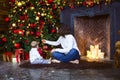 Mother with her baby boy siting near the Christmas tree Royalty Free Stock Photo