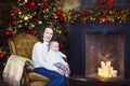 Mother with her baby boy siting near the Christmas tree Royalty Free Stock Photo