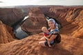 A mother and her baby boy are sitting at the edge of the cliff n Royalty Free Stock Photo