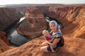 A mother and her baby boy are sitting at the edge of the cliff n Royalty Free Stock Photo