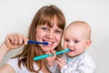 Mother and her baby brushing teeth together Royalty Free Stock Photo